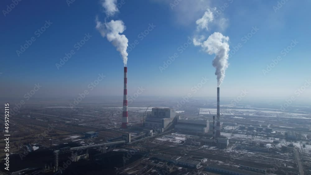 View of a working thermal power plant, smoke from a chimney, video filming from the air View of a working thermal power plant, smoke from a chimney, video filming from the air