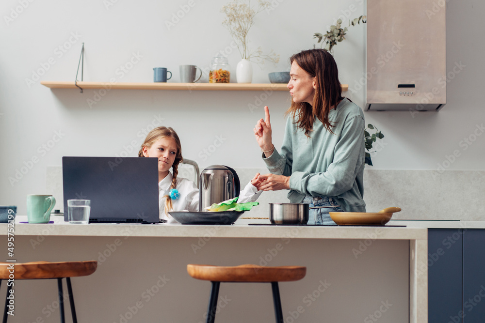 Mother cooks food at home in the kitchen Mother cooks food at home in the kitchen
