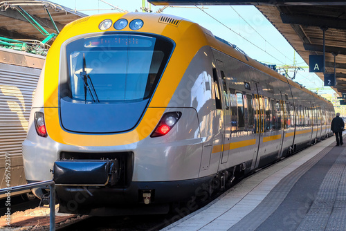 modern high-speed railway train in yellow-grey color on the platform