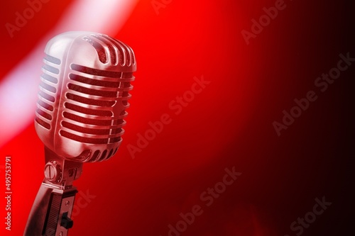 Classic vintage retro microphone. Object illuminated with colored light on the background