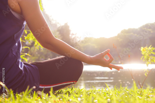 The concept of relieving back and muscle pain massaged bya woman exercising in the park