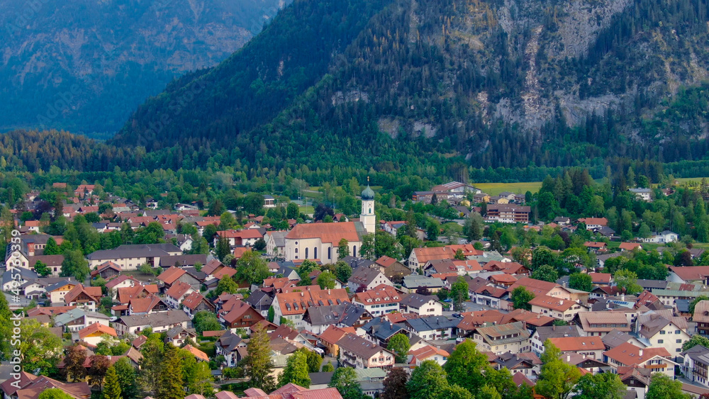 Aerial view over the city of Oberammergau in Bavaria Germany. High quality 4k drone footage