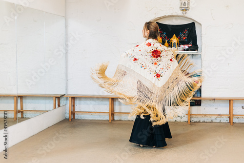 Flamenco woman dancer on her back with manila shawl in motion