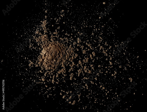 Organic linseed protein powder pile isolated on black, top view 