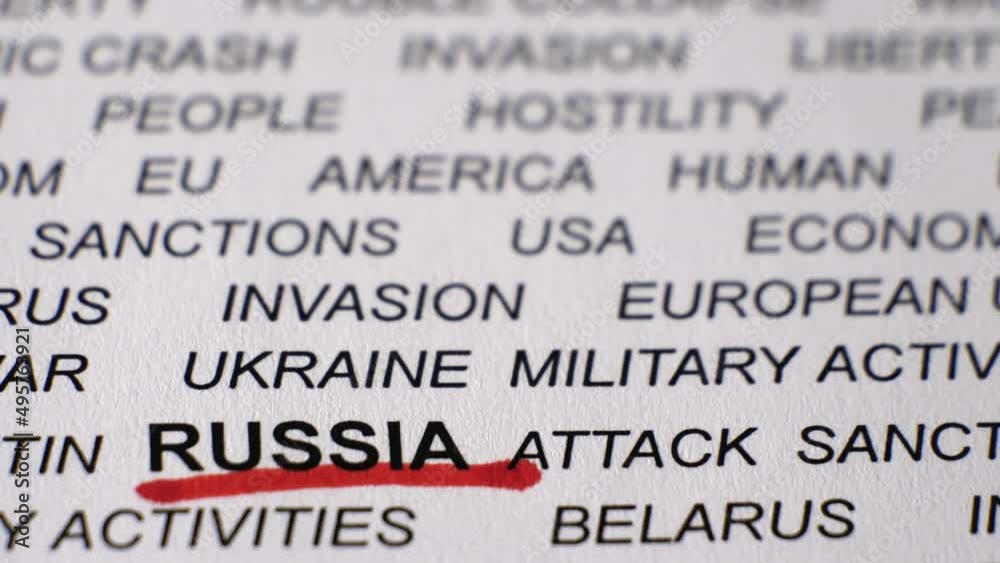 Closeup shot of RUSSIA written on white paper with a red line under it. Russian invasion of Ukraine concept. Sanctions. Crisis. Military activities. Camera moving backwards and sideways.