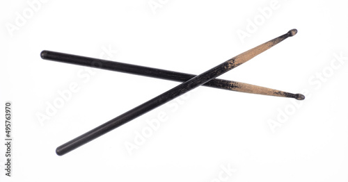 black old wooden drumsticks isolated on white background photo