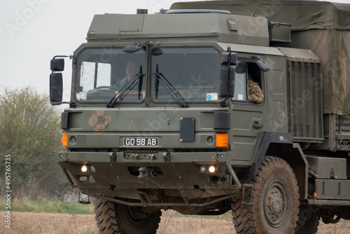 Fotografiet British army MAN SV 4x4 army logistics lorry vehicle truck driving along a dirt
