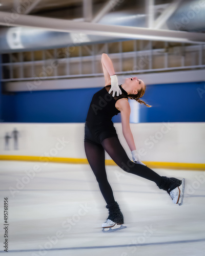 Woman doing a nice figure in ice skating with motion blur effect