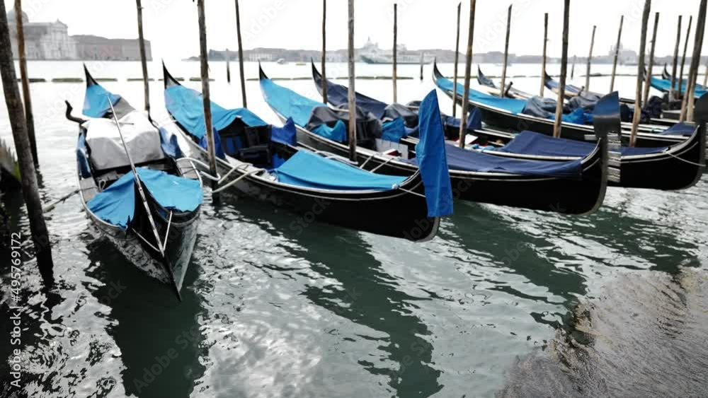 Venice, Italy - gondolas and gondoliers in the Grand Canal near the Rialto Bridge, in the San Marco Basin and between the canals of the lagoon city Venice, Italy - gondolas and gondoliers in the Grand Canal near the Rialto Bridge, in the San Marco Basin and between the canals of the lagoon city