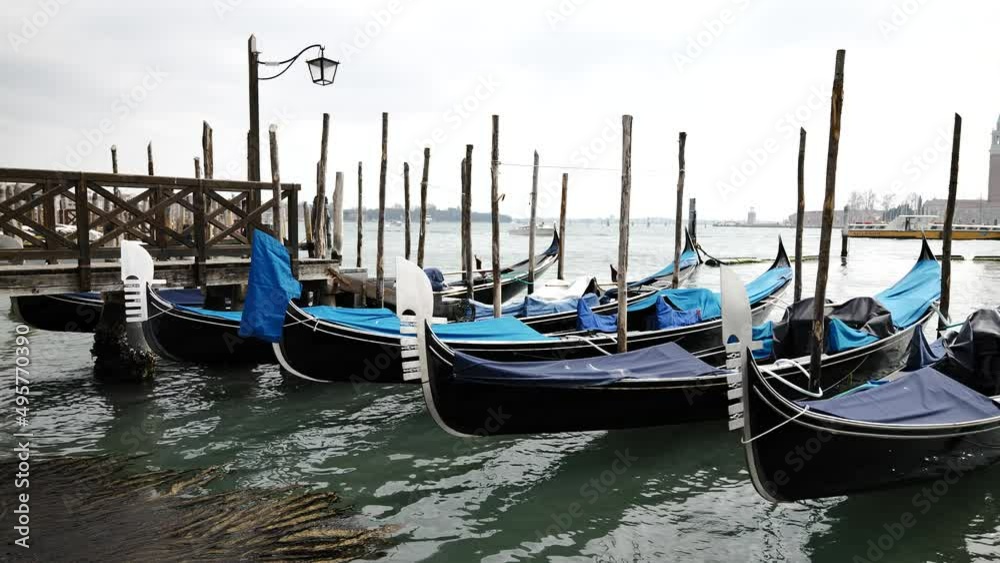 Venice, Italy - gondolas and gondoliers in the Grand Canal near the Rialto Bridge, in the San Marco Basin and between the canals of the lagoon city Venice, Italy - gondolas and gondoliers in the Grand Canal near the Rialto Bridge, in the San Marco Basin and between the canals of the lagoon city