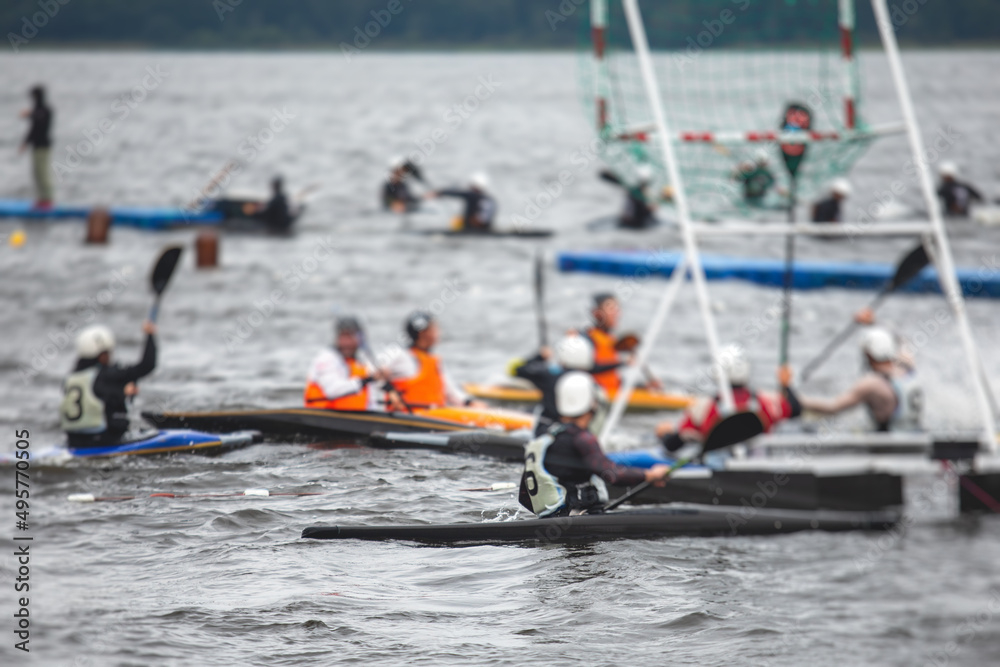 Naklejka premium Canoe polo match, two teams play kayak polo game outdoor competition in the lake river, water sport