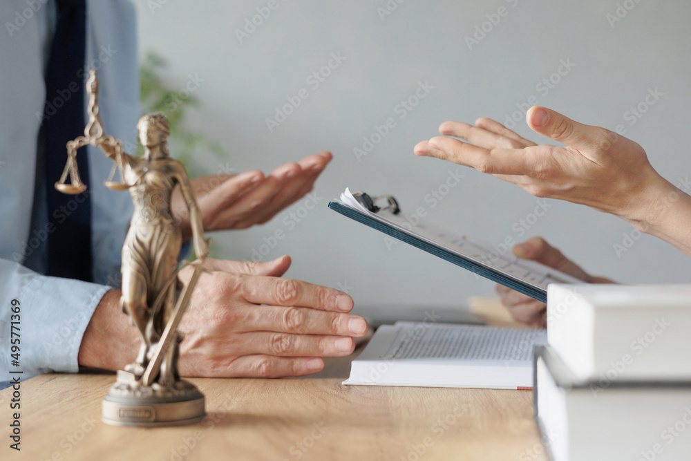Fototapeta premium a female lawyer at a meeting with a male client in the office of the law office, legal advice online. resolution of disputes of the family code during divorce and division of property. work as a