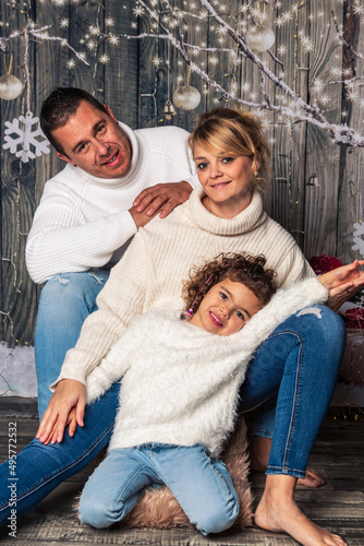 Adorable Spanish family having a groupie during a Christmas event