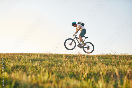 Cyclist Riding the Bike on the Trail in the Forest. Man cycling on enduro trail track. Sport fitness motivation and inspiration. Extreme Sport Concept. Selective focus