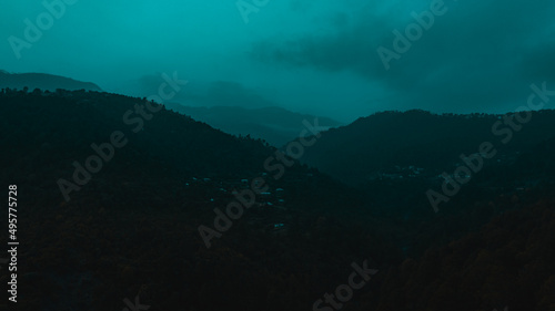 Mountains covered with trees under blue sky