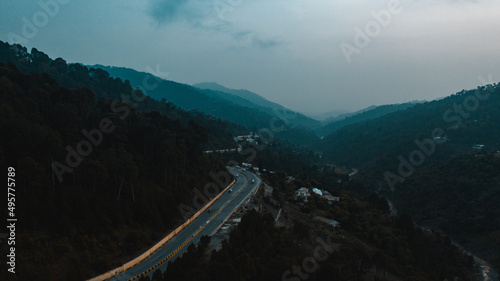 Aerial view of road in the middle of green mountains