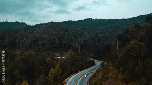 Aerial view of road in the middle of green mountains