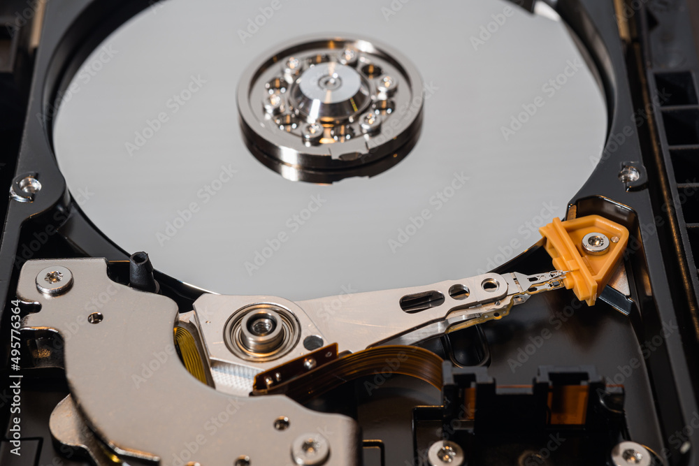 Mechanical parts of hard drive disk (HDD) inside a computer. Mechanical parts of hard drive disk (HDD) inside a computer.