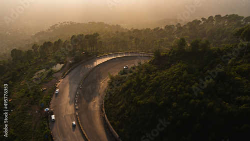 Aerial view of road in the middle of green mountains