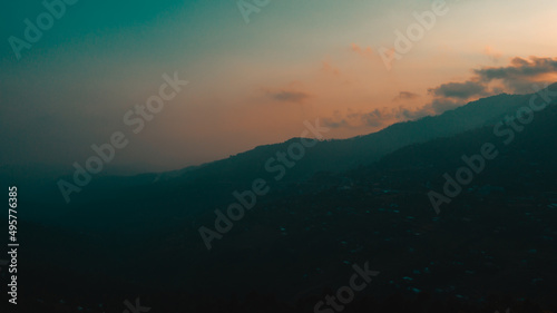 Silhouette of mountain under cloudy sky