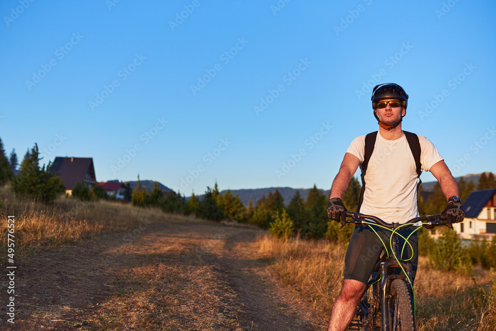 Cyclist Riding the Bike on the Trail in the Forest. Man cycling on enduro trail track. Sport fitness motivation and inspiration. Extreme Sport Concept. Selective focus Cyclist Riding the Bike on the Trail in the Forest. Man cycling on enduro trail track. Sport fitness motivation and inspiration. Extreme Sport Concept. Selective focus