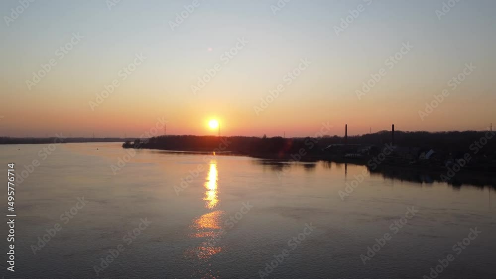 Silhouette of small town near river Scheldt during golden sunset, aerial view Silhouette of small town near river Scheldt during golden sunset, aerial view