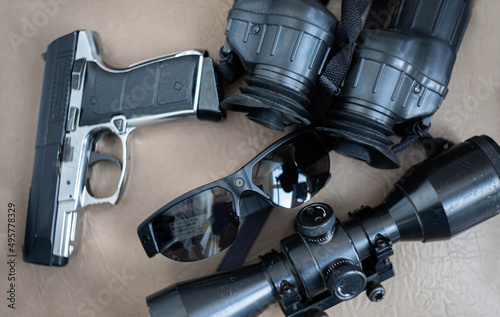 weapons and gadgets for a spy scout, glasses with a surveillance camera, a pistol, binoculars. Equipment of a special services agent