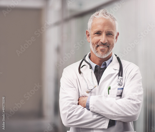 Let me help take care of your overall health. Portrait of a mature male doctor standing in a hospital.