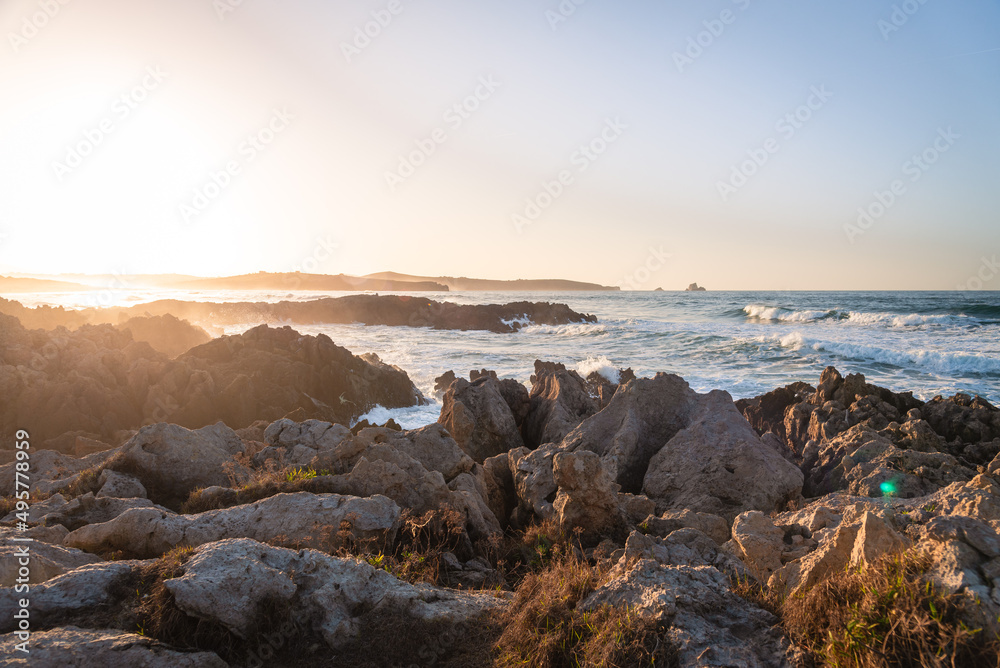The Cantabrian sea from the rocky shore of the beach of Canallave at sunset, Dunas de Liencres Natural Park and Costa Quebrada, Cantabria, Spain