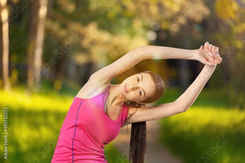 Healthy female athlete enjoy outdoor lifestyle sport training workout. Woman in sportswear and smartwatch stretching body. © BillionPhotos.com