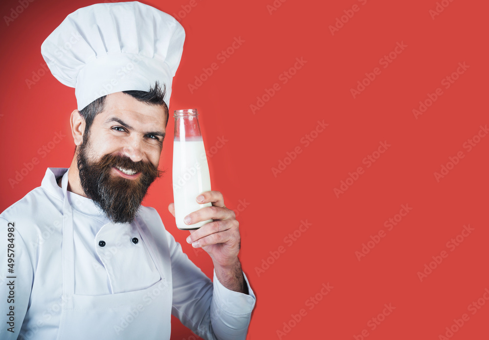 Dairy products. Smiling chef in white uniform with bottle of milk. Bearded cook with milkshake. Dairy products. Smiling chef in white uniform with bottle of milk. Bearded cook with milkshake.