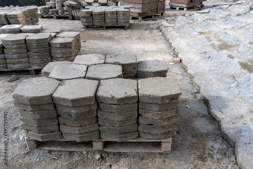 Old paving slabs in close-up. Storage of paving slabs during the repair of roads and pedestrian areas. Reconstruction of urban infrastructure.