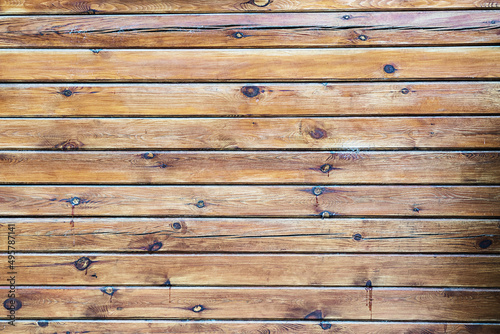 Wooden surface with horizontal planks with small swirls. Natural background.