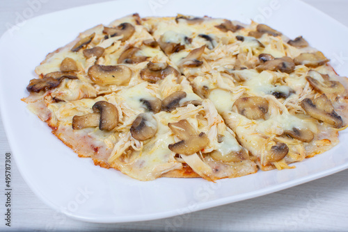 Traditional pizza with mushrooms, with cheese, pomodoro pasta on checkered napkin