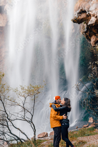 Joven pareja de enamorados besándose frente a la cascada del Salto de la Novia, situado en la localidad de Navajas (Castellón)