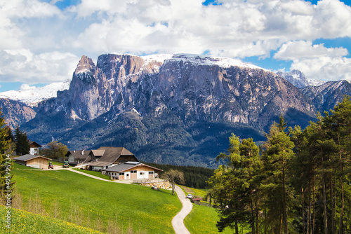 High angle of an Italian village on the hill with the background of mountain Schlern photo