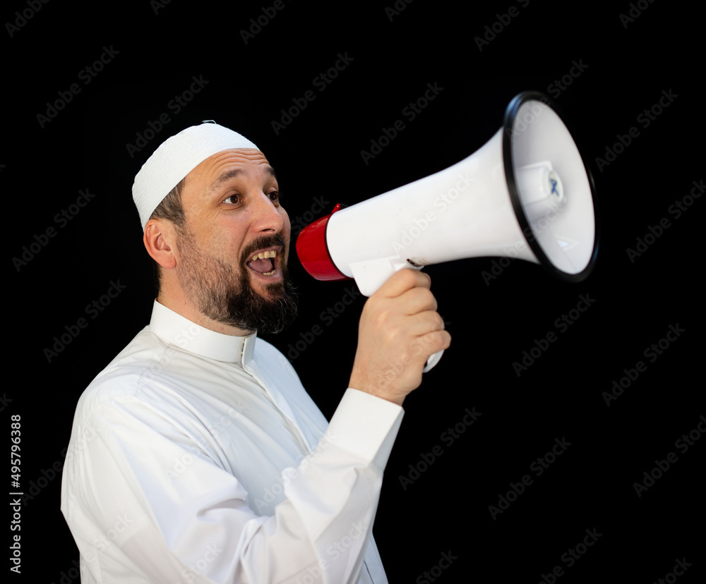 Muslim pilgrim in white traditional clothes, saying message on megaphone. High quality photo Muslim pilgrim in white traditional clothes, saying message on megaphone. High quality photo