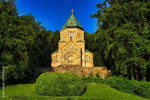 Votivkapelle Chapel St. Louis in Bavaria, Germany surrounded by green trees on a sunny day photo