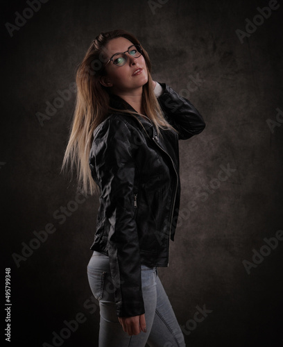 Attractive young woman poses for the camera - studio photography