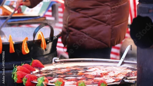 2 mulled strawberry wine in a metal cauldron that evaporates photo