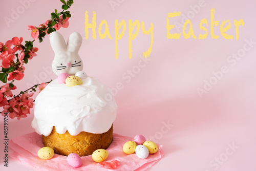 Easter card  cake and colorful eggs and Easter decorative bunny on a pink background with spring cherry blossoms and  text Happy Easter and copy space. Easter Ukraine orthodox .Easter card concept