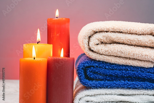 Towels bent on top of each other with candles around 