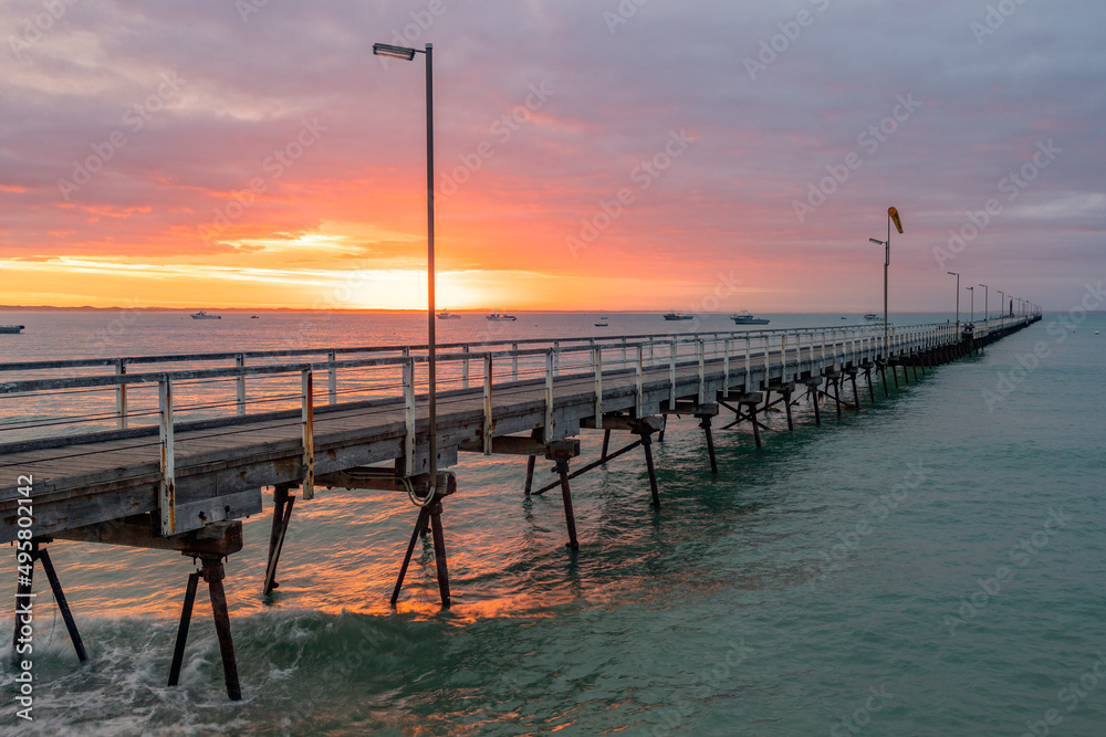 A glowing sunrise over the iconic Beachport Jetty located in the southeast of South Australia taken on February 20th 2022