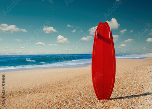 Photography Beautiful beach with a red surfboard in the sand