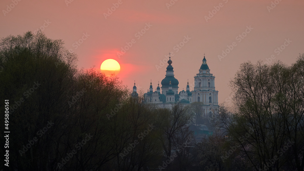 Ancient ukrainian cathedral of st. Trinity at the red sunset