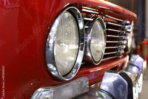 Front Side Head Lights An Bumper Of A Red Colored antique car © danielfela