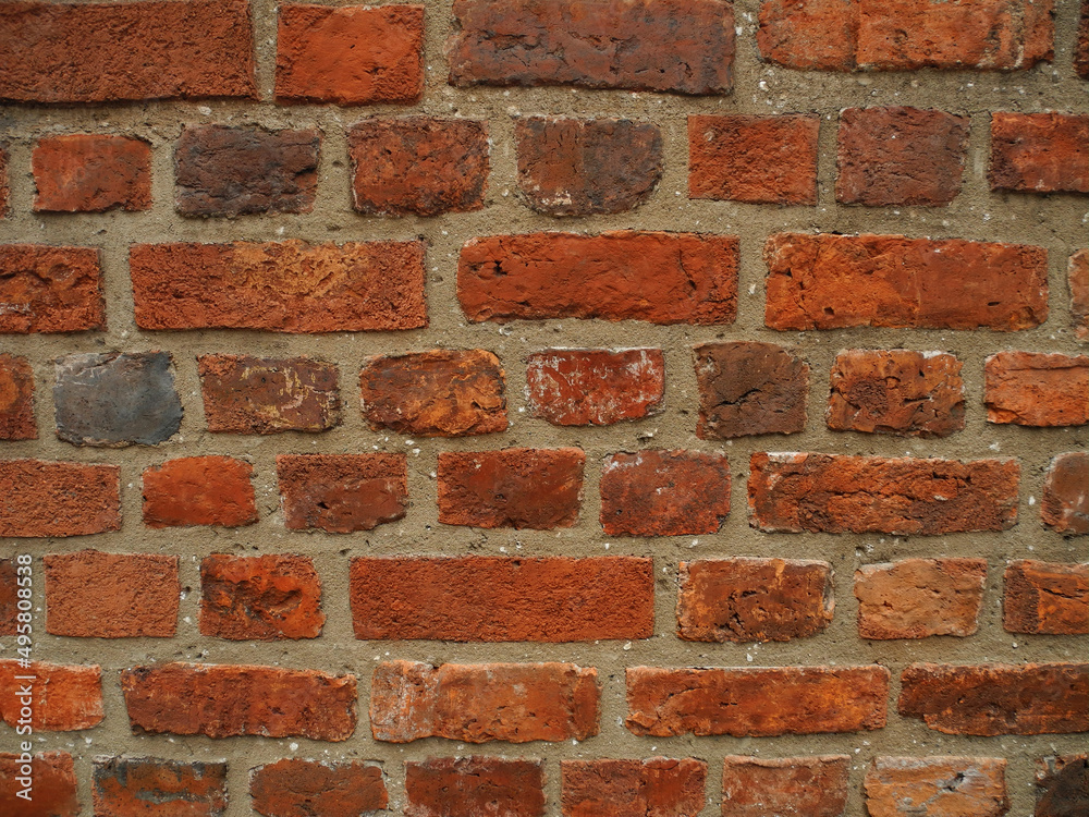 Old wall made of bricks of various sizes. Background for design. Old wall made of bricks of various sizes. Background for design.