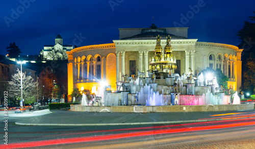 Night view of grandiose composition of Colchis Fountain on main square of Kutaisi on background of Lado Meskhishvili State Academic Theatre in spring, Georgia photo