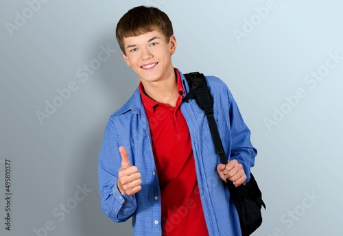 Advertising concept. High school student in wearing in t-shirt with backpack. photo