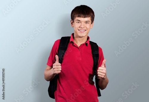 Advertising concept. High school student in wearing in t-shirt with backpack. photo